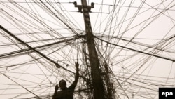 An electrician checks the wires leading to a block of flats in Baghdad's Karrada district 