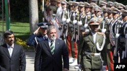 President Mahmud Ahmadinejad and his Brazilian counterpart Luiz Inacio Lula da Silva review an honour guard in Tehran