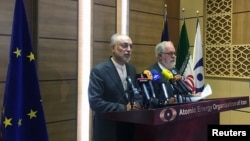 Iran's nuclear chief Ali Akbar Salehi (left) speaks during a joint press conference with European Commissioner for Energy and Climate Miguel Arias Canete in Tehran on May 19.