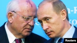 Russian President Vladimir Putin (right) listens to former Soviet President Mikhail Gorbachev during a news conference in Schleswig in northern Germany in December 2004 following a German-Russian summit.