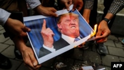 Iranians burn an image of U.S. President Donald Trump during a demonstration outside the former U.S. Embassy in Tehran on May 9.