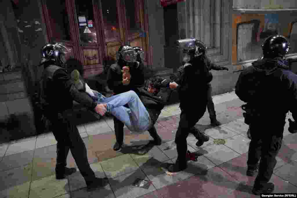 A protester is detained by riot police on Tbilisi&#39;s central Rustaveli Avenue on November 30. The level of violence shown by police forces resulted in the EU imposing visa restrictions on Georgian diplomats and government officials.