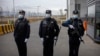 Police officers stand at the outer entrance of detention center in China's western Xinjiang region.