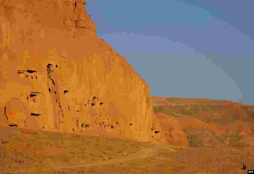 A man walks in November 2005 near a cavernous space left empty when the Taliban destroyed the Bamiyan Buddhas in 2001.