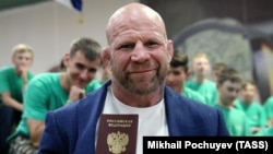 Jeff Monson poses with his Russian passport in June.