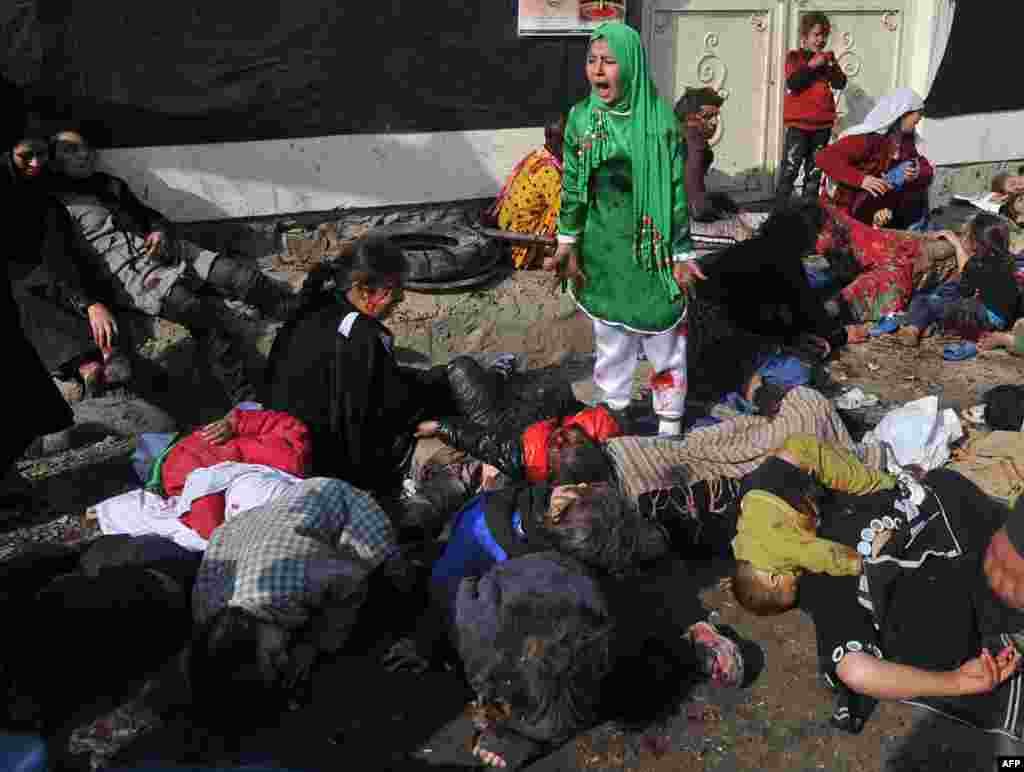 The photograph that was awarded the Pulitzer Prize, showing Tarana Akbari reacting amid the casualties after the suicide bombing at a crowded Shi&#39;ite shrine in Kabul on December 6, 2011.