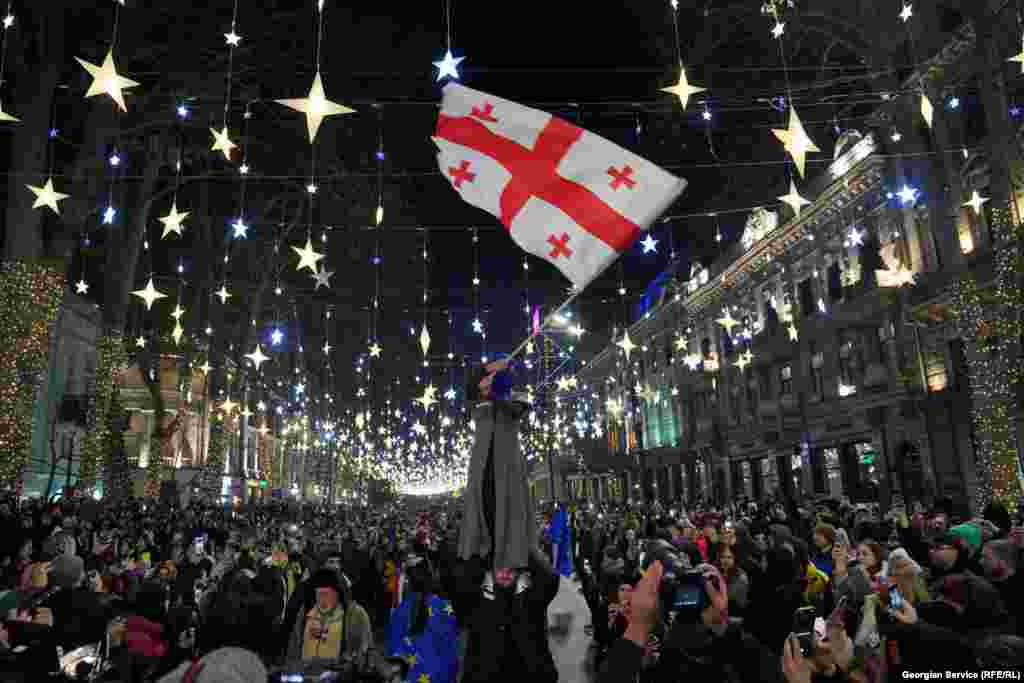 Protesters photographed under Christmas lighting on Rustaveli Avenue on December 21.&nbsp;