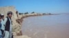 Village elder Hadji Khaleq inspects the ruins of a home in Yaz Ariq Dinar destroyed by the advancing Amu Darya river