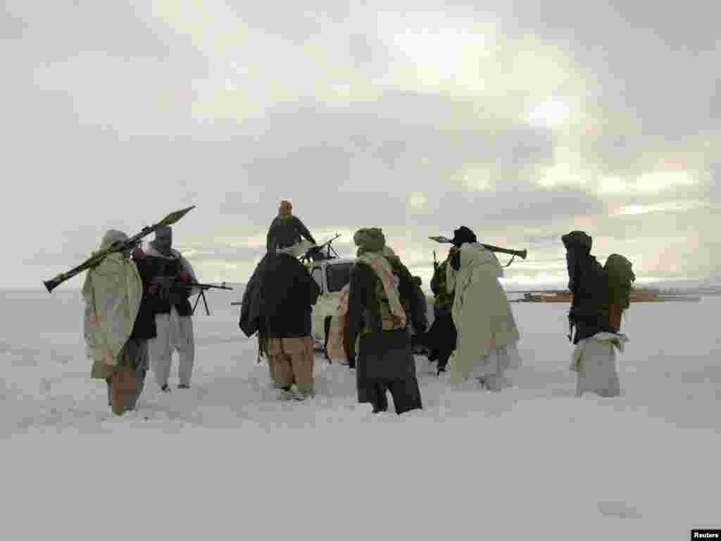 Taliban militants are seen with their weapons in an undisclosed location in Afghanistan in January 2009.