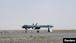 A U.S. Predator unmanned drone armed with a missile stands on the tarmac of the Kandahar military airport in Afghanistan.