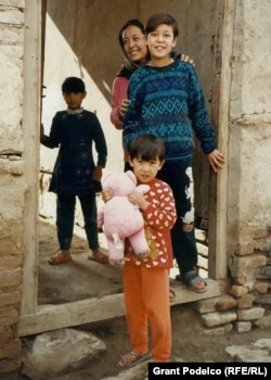 Anwari's daughters play outside their home in Kabul in November 2002.