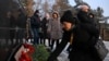 People lay flowers at an impromptu shrine to pay tribute to the miners and rescuers killed in an accident at the Listvyazhnaya coal mine in Kemerovo. 