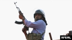 A Basij militia member watches over a Tehran demonstration in June.