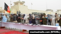 Afghan Taliban militants disarm in December 2011.