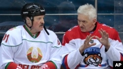 Russian oligarch Gennady Timchenko (right) speaks with Belarusian strongman Alyaksandr Lukashenka during an ice hockey game at Shayba Arena in Sochi, Russia, in 2019. 