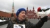 A Communist Party supporter waits to pay her respects recently at the grave of Soviet leader Josef Stalin, at the Kremlin wall on Red Square in Moscow.