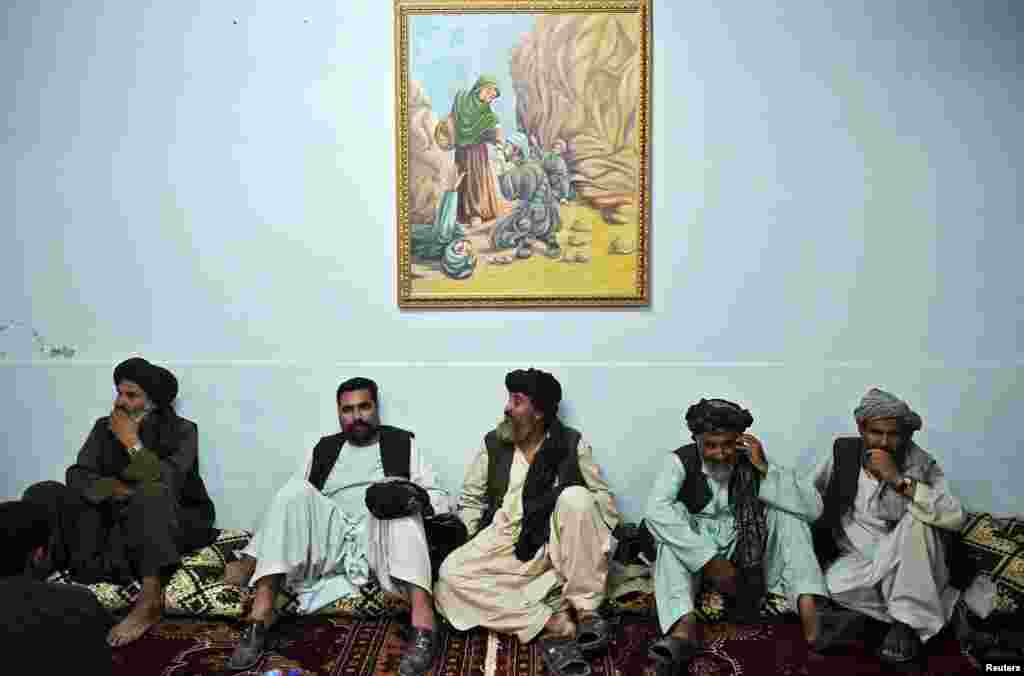 Pashtun leaders listen to President Hamid Karzai speak at a meeting with tribal leaders in Kandahar in June 2010.