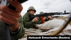 Russia-backed fighters take part in a training exercise outside the separatist-controlled city of Luhansk in eastern Ukraine in September.