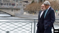 Iranian Foreign Minister Mohammad Javad Zarif (left) was criticized by hard-liners back home for taking a stroll with U.S. Secretary of State John Kerry during a break in nuclear negotiations in Geneva in January. 