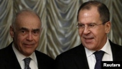 Egyptian Foreign Minister Muhammad Amr (left) and Russian Foreign Minister Sergei Lavrov arrive for a bilateral meeting in Moscow on December 28.