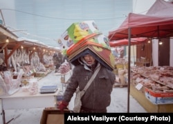 A worker carries boxes at the coldest market in the world, where frozen meat and fish are sold in the open.