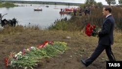 Then-President Dmitry Medvedev laying flowers at the site where the Yak-42 passenger plane crashed near Yaroslavl in September 2011, killing all the Lokomotiv team members aboard.