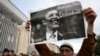 A man holds a sign investing hope in U.S. President Barack Obama at a Georgian opposition rally in Tbilisi in November 2008.