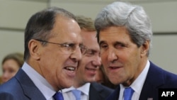 Russian Foreign Minister Sergei Lavrov (left) speaks with U.S. Secretary of State John Kerry