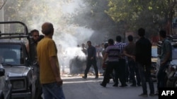 Iranian protesters scuffle with police in central Tehran on October 3.