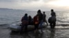 Afghan migrants disembark on a beach on the Greek island of Kos after crossing the strait from Turkey, in May. 