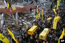 Mourners carry the coffins of Hezbollah fighters, killed in the war with Israel, in Maarakeh village, southern Lebanon in November.