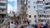 Russian emergency services work on May 12 at the scene of a partially collapsed building in Belgorod.