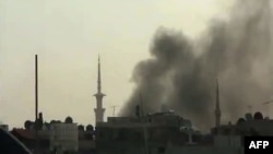 Smoke billows from the scene of reported shelling in Duma, Syria.