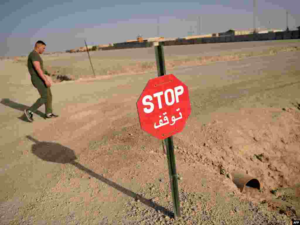 A U.S. marine walks on a road at Forward Operating Base Delaram in Helmand Province in 2011.