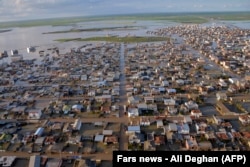 An image shows flooded streets in the northern Iranian village of Agh Ghaleh on March 23.