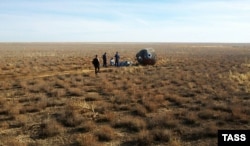 A search-and-rescue team arrives at the emergency landing site on the Kazakh steppe on October 11.