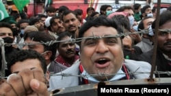 A supporter of the Pakistan Democratic Movement (PDM), an alliance of political opposition parties, chants slogans at an anti-government protest rally in Lahore on December 13. 