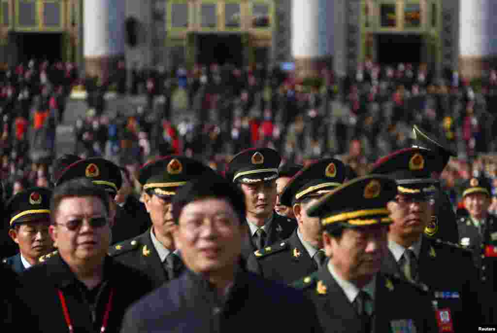 Military delegates leave the Great Hall of the People after the opening ceremony.