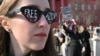 A woman wearing sunglasses with the message "Free Azov" joins relatives and friends of Ukrainian prisoners of war from the Azov Brigade and other units in Kyiv on March 9 to call for their exchange with Russian prisoners.