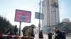 Ukrainian servicemen are seen near an apartment building damaged by shelling in Kyiv on February 26.