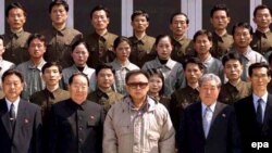 North Korean leader Kim Jong-il poses with scientists after observing the launch