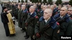 An Orthodox priest blesses young recruits to Ukraine's armed forces in 2013, which was the final year in which conscripts were called up to the army. 