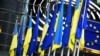 The flags of Ukraine and the European Union hang together outside the European Parliament in Brussels.