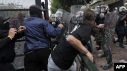 Protesters clash with riot police in Athens on October 9.