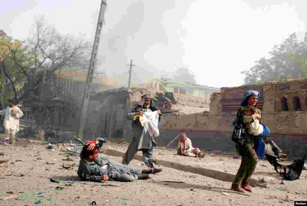 Locals escape the scene of a deadly suicide attack on the Indian Embassy in Kabul in July 2008.