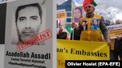 Iranian opposition activists protest with a portrait depicting Iranian official Asadollah Assadi in Brussels in October 2018.