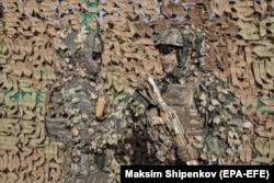 Russian servicemen display military camouflage equipment during the military exercises in the Orenburg region in September.