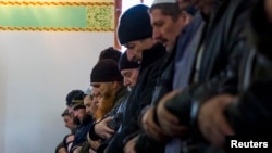 Crimean Tatars pray in the Khan Chair mosque in Bakhchisaray, near Simferopol.