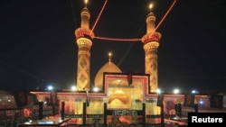 Shi'ite pilgrims pray at the Imam Abbas shrine in the holy city of Karbala.