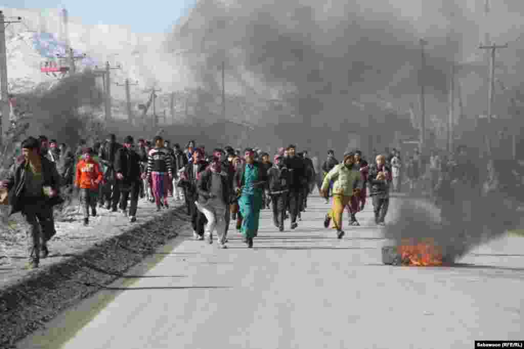 Demonstrators on a main street as protests in Kabul Province continued on February 22.